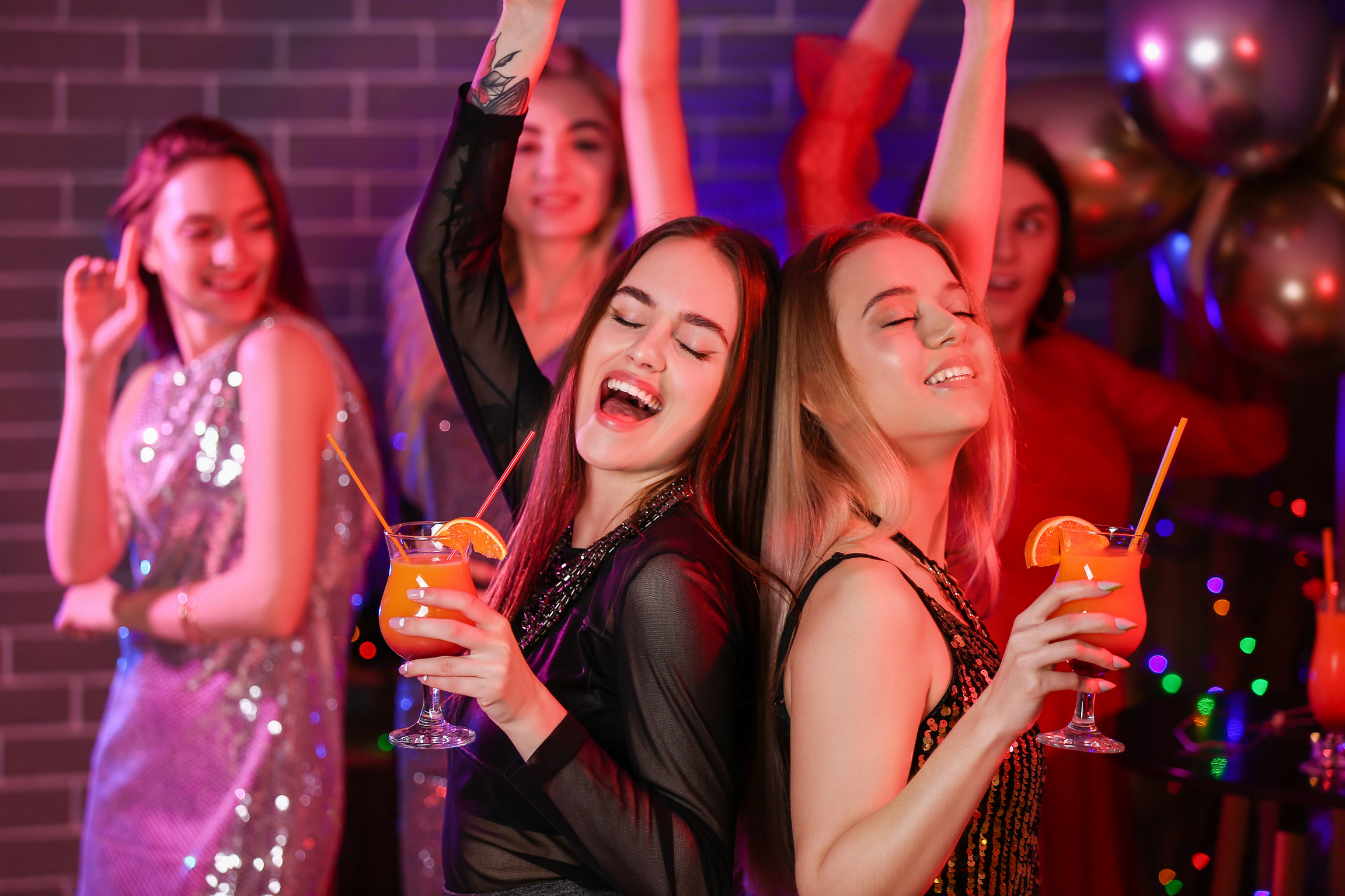 Beautiful Young Women Dancing in Night Club
